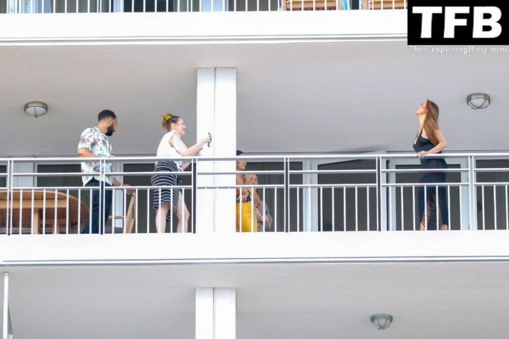 Chrissy Teigen & John Legend Kiss and Pose During an Impromptu Balcony Shoot - #1