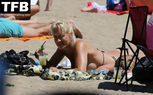 Sarah Connor Flashes Her Nude Breasts on the Beach on modelclub.info