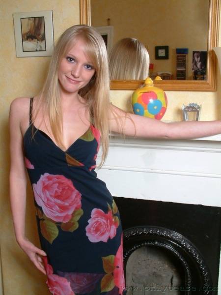 Nice Blonde Chickie Sharon Posing In Dress And Lingerie By The Fireplace photos (Sharon Onlytease) - definebabe.com